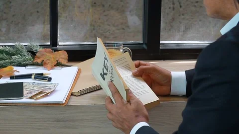 Business manager reading book and drinking coffee.  Stock Footage 102391483