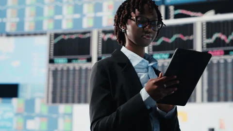 Business manager showing graphs on digital screens at event Stock Footage 318856223