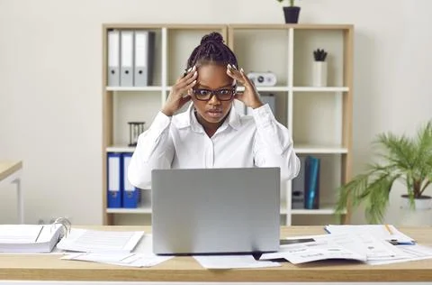 Business manager using her office laptop computer and having problem due to Stock Photos