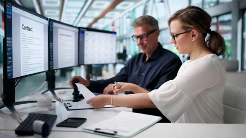 Business Managers Reviewing Documents Together For Final Approval Stock Footage 337225520
