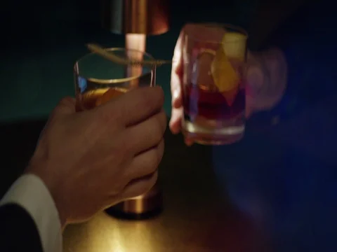 Business men cheering at night time clinking glasses of whiskey Stock Footage 70802995