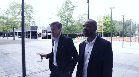 Business men entering office building Stock Footage 59396848