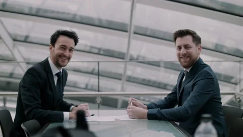 Business men looking at the camera smiling Stock Footage 131027240