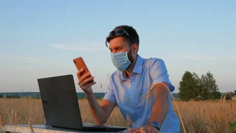 Business men at remote work. A young man wearing a Covid-19 mask Stock Footage 136821733