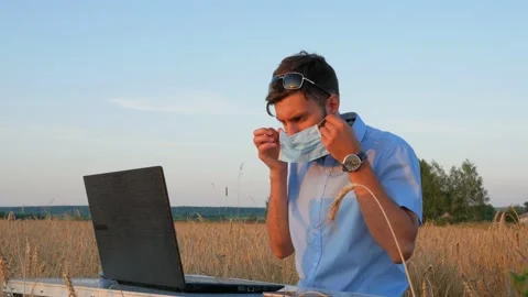 Business men at remote work. A young man wearing a Covid-19 mask Stock Footage 136821764