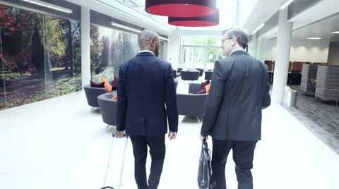 Business men sitting in office lobby and having a discussion Stock Footage 59397186