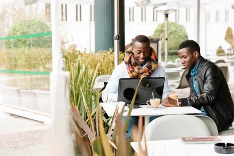 Business men using mobile and laptop in the coffee shop. Stock Photos
