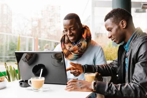 Business men using mobile and laptop in the coffee shop. Stock Photos