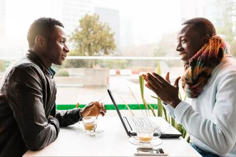 Business men using mobile and laptop in the coffee shop. Stock Photos