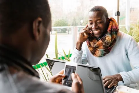 Business men using mobile and laptop in the coffee shop. Stock Photos