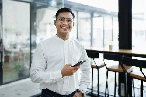 Business owner or Asian male marketers are using business phones in office work Stock Photos