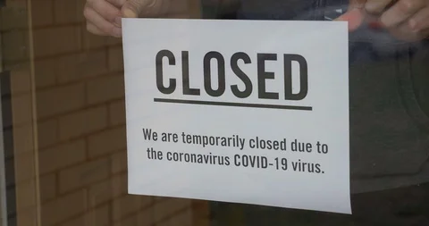 Business Owner Puts Closed Sign on Door Due to COVID-19 Stock Footage