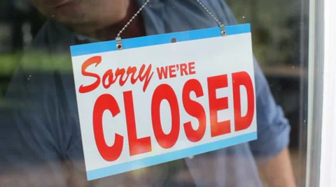 Business owner turns sign from open to closed Stock Footage