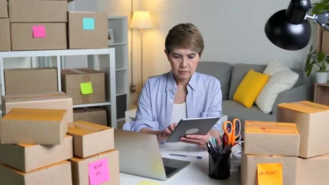 Business owner using tablet checking address and delivery detail before shipping Видео 160883596