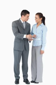 Business partner analyzing data against a white background Stock Photos