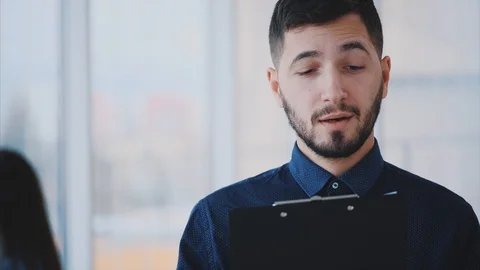 A business partner keeps a folder in his hands while reading a new contract. Stock Footage 102391616