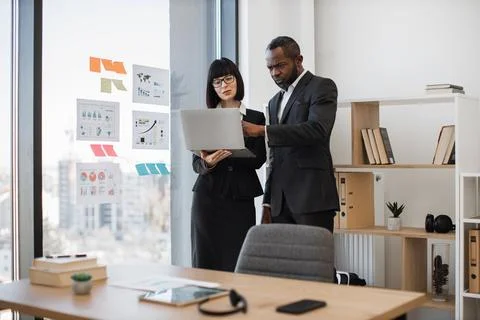 Business partners developing plan in office using computer Stock Photos