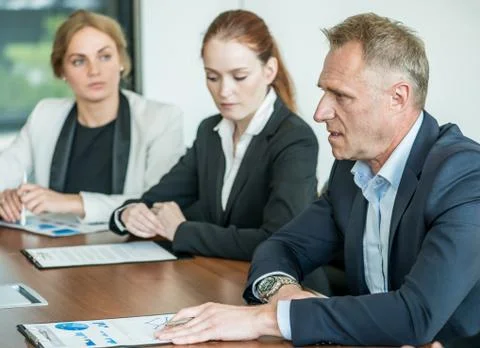 Business partners discussing documents Stock Photos