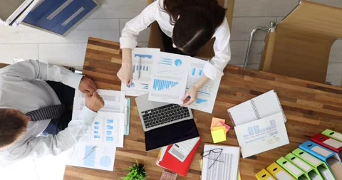 Business partners examine stack of important documents at table Stock Footage 307903339