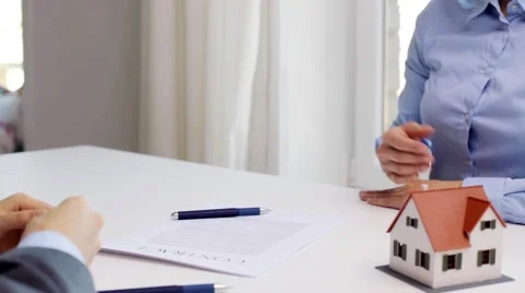 Business partners with house keys and contract Stock Footage