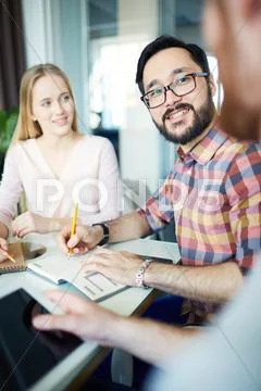 Business partners interacting at meeting Stock Photos