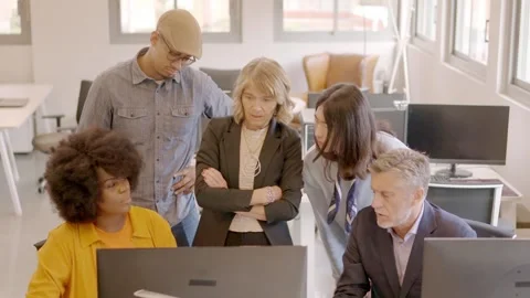 Business partners looking at the same computer in a coworking Video stock 262231241