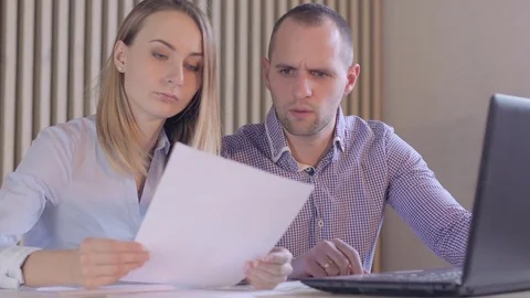 Business partners with papers and a computer Stock Footage 72983412