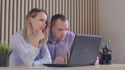 Business partners with papers and a computer 스톡 동영상 72984167