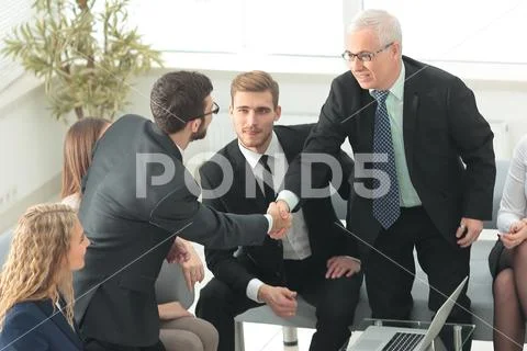 Business partners shake hands at a business meeting in the office Stock Photos