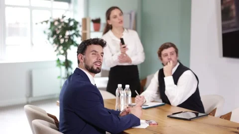 Business partners sitting at table and chatting, colleague with remote control Stock-Footage 345572190