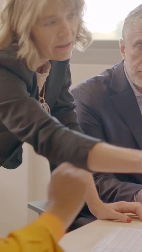 Business partners talking and using computer together in a coworking space Stock Footage 260851853