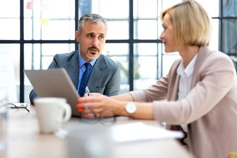Business people are working using digital tablet and smiling while standing i Stock Photos