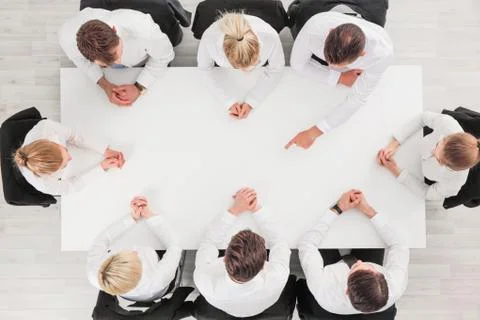 Business people around empty table Stock Photos