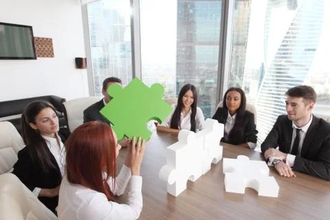 Business people assembling puzzle Stock Photos