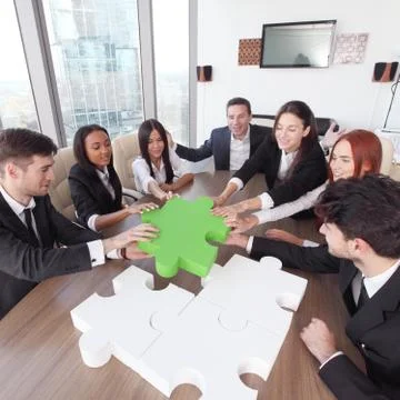 Business people assembling puzzle Stock Photos