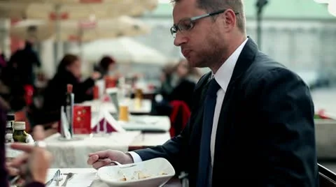 Business people with cellphone eating dinner in the restaurant, outdoor Stock Footage
