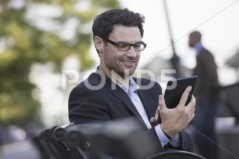 Business people in the city. keeping in touch on the move. a man seated on a Stock Photos