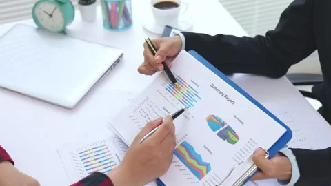 Business people collaborating on financial data and performance charts. Cor.. 스톡 동영상 337998154