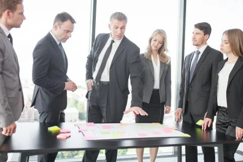 Business people developing plan on office desk Stock Photos