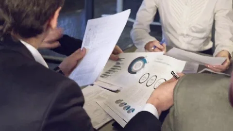 Business people exchanging documents, closeup shot Stock Footage 69124577