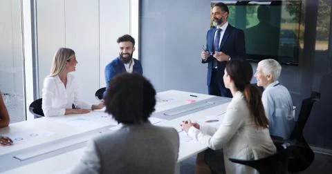 Business People Having Board Meeting In Modern Office Stock Photos
