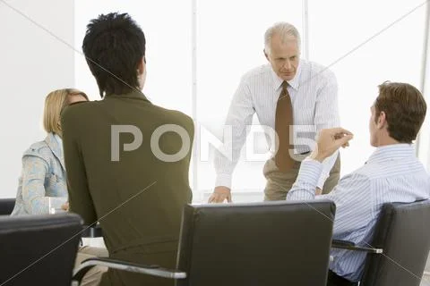 Business People Having Discussion In Conference Room Stock Photos