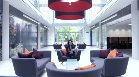 Business people having a discussion in office lobby Stock Footage 59383966