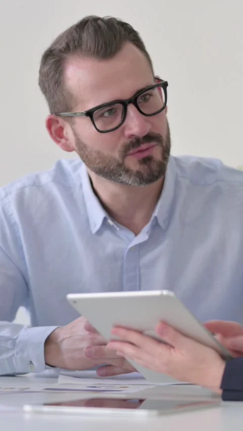 Business People having Discussion while using Tablet, Vertical Video Stock Footage 340036231