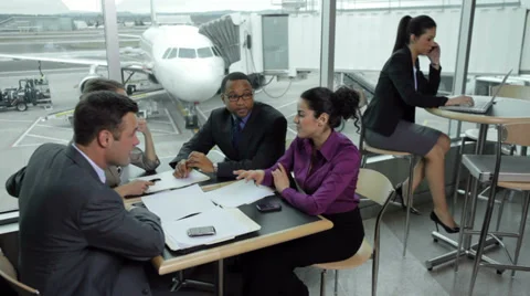 Business people having meeting at airport Stock Footage