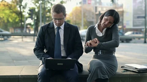 Business people with laptop and cellphone in the city, steadicam shot HD Stock Footage