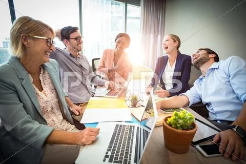 Business People Laughing During A Meeting In The Office