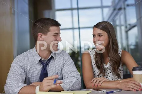 Business People Laughing In Office Meeting