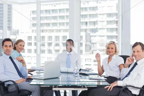 Business people looking at camera during a meeting Stock Photos