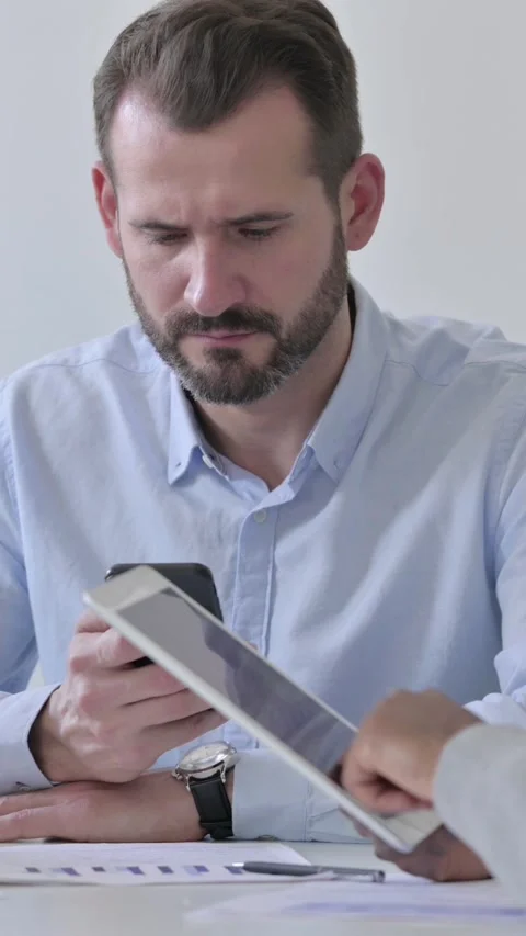 Business People Preparing Report while using Smartphone and Tablet, Vertical 스톡 동영상 340035791